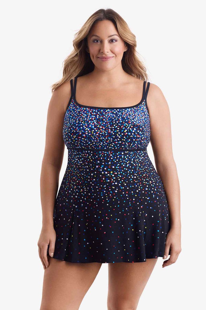 Woman wearing a swim dress with a multicolored dot pattern