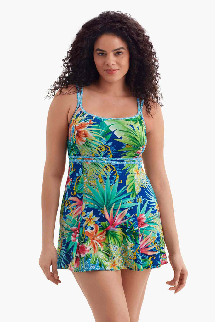 Woman wearing a multicolored swim dress with a palm leaf pattern