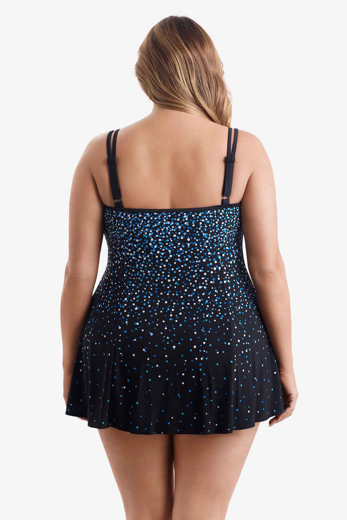 Woman turned away wearing a swim dress with a blue and white dot pattern