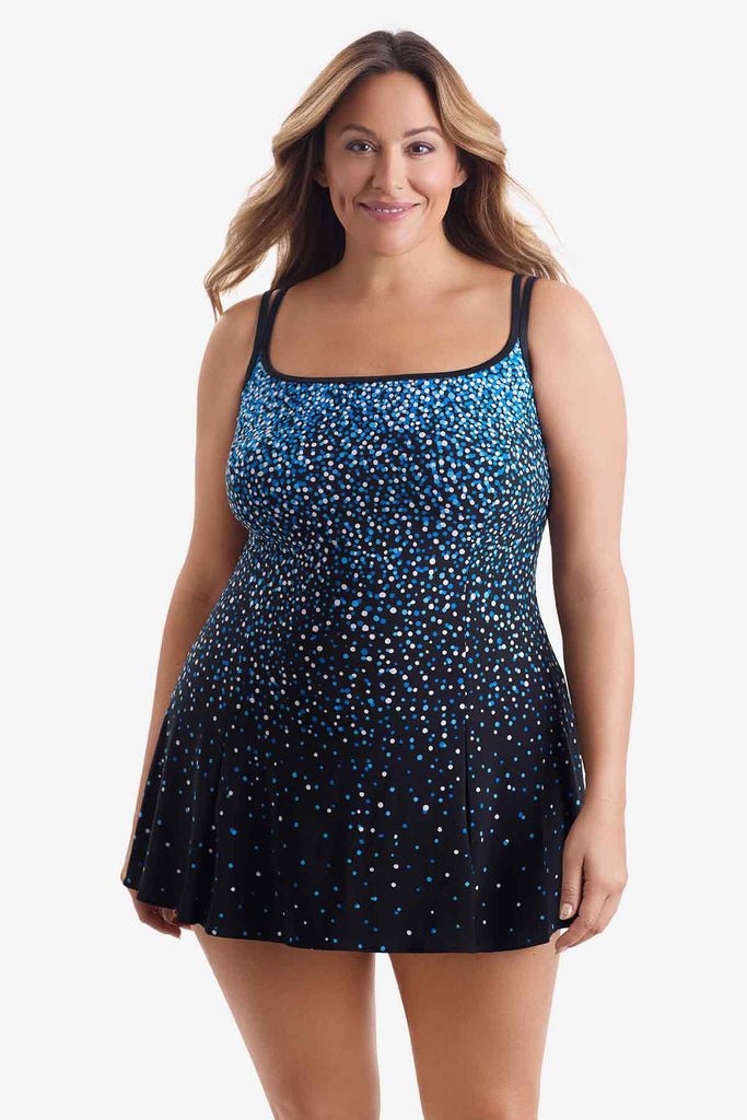 Woman wearing a swim dress with a blue and white dot pattern