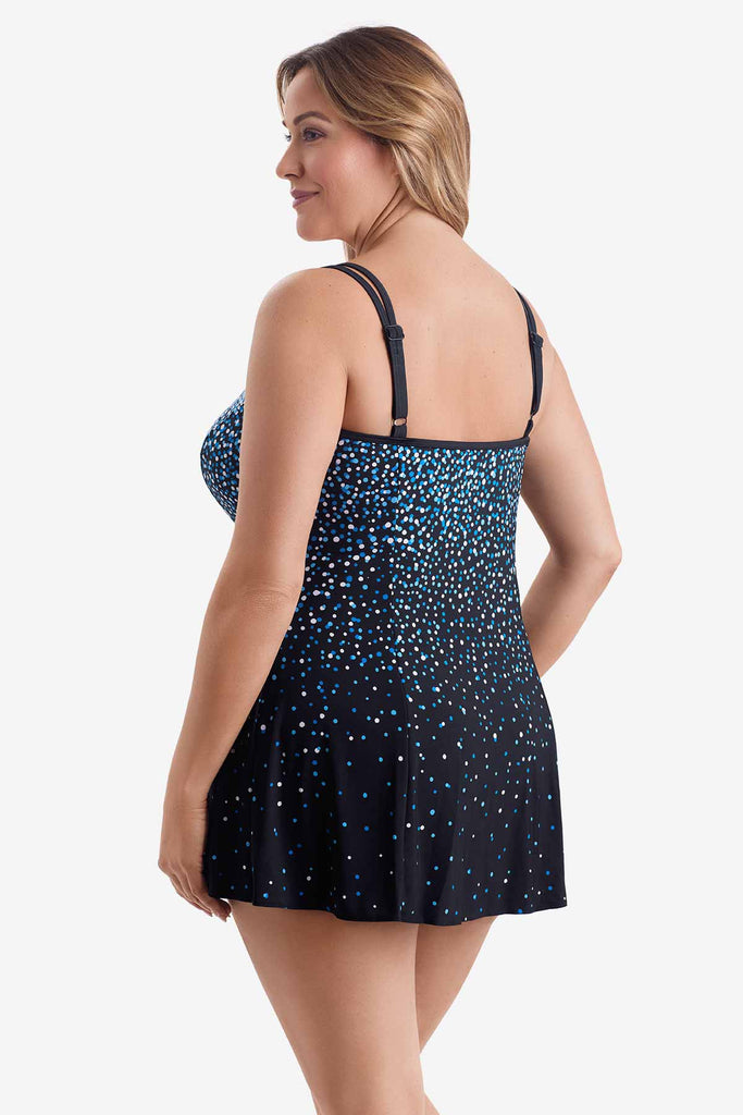 Woman turned left wearing a swim dress with a blue and white dot pattern