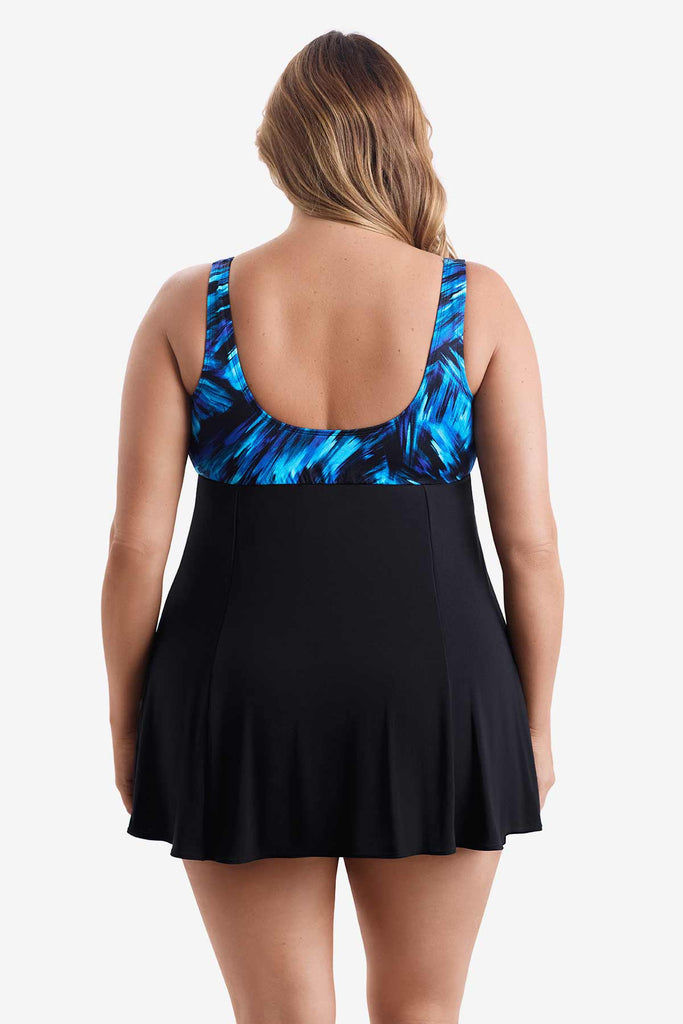 Woman faced away wearing a swim dress with a black and blue print on the bust