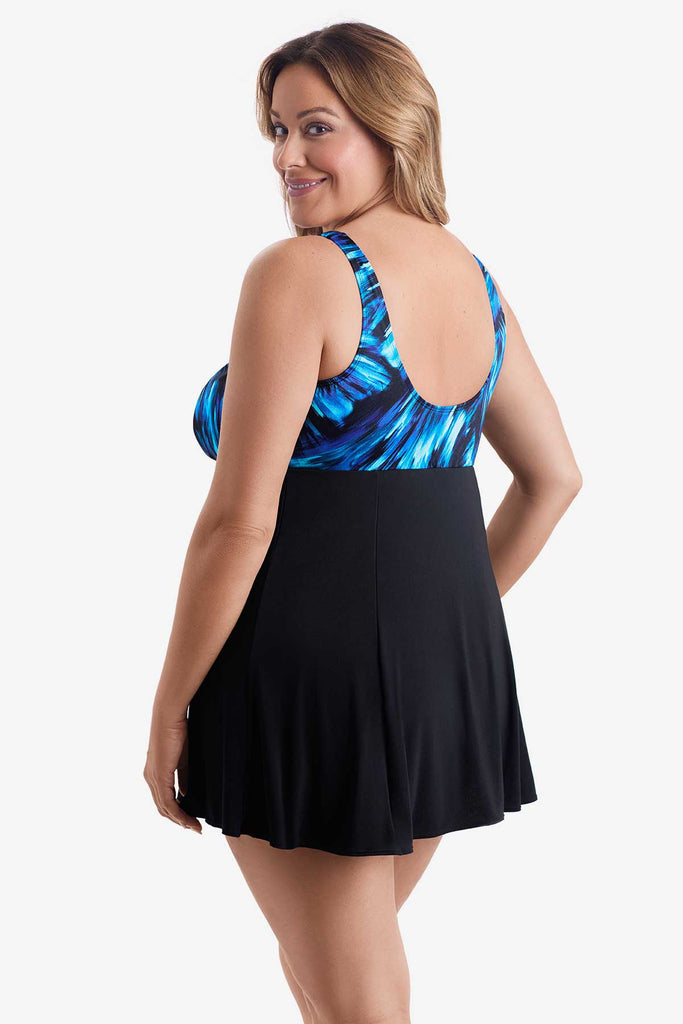 Woman faced left wearing a swim dress with a black and blue print on the bust