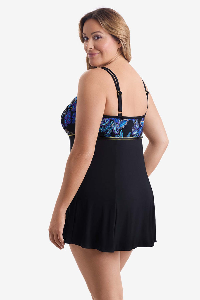 Woman turned left wearing a swim dress with a blue floral print on the bust