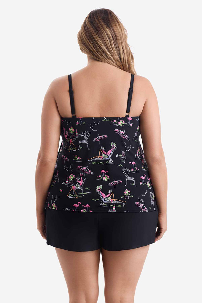 Woman faced away wearing a ruffle one-piece swimsuit with a flamingo pattern