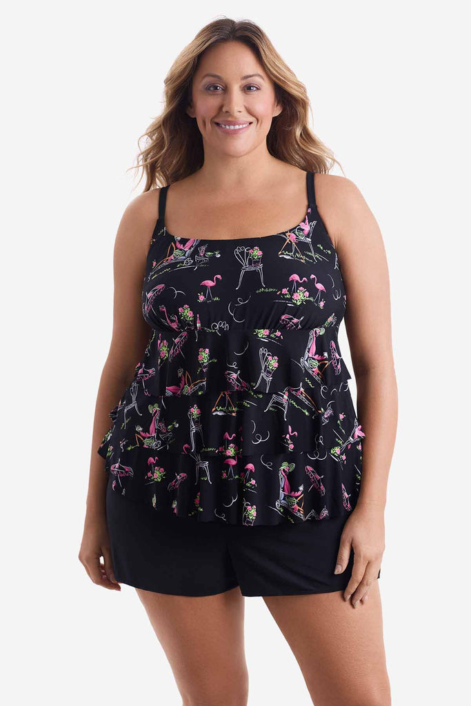 Woman wearing a ruffle one-piece swimsuit with a flamingo pattern