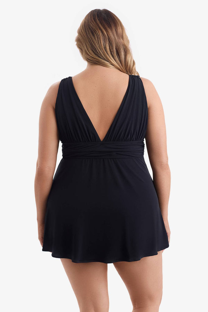 Woman turned away wearing a black swim dress with a V neckline