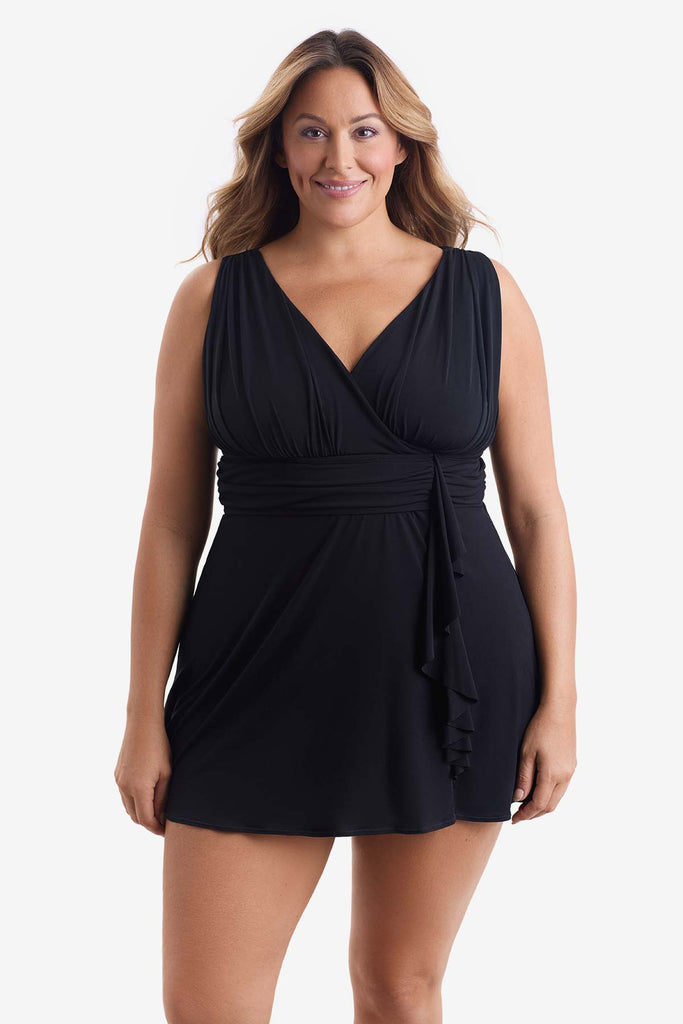 Woman wearing a black swim dress with a V neckline