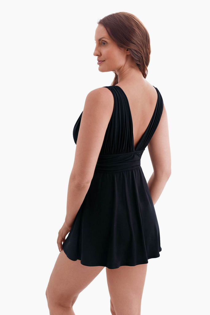 Woman turned left wearing a black swim dress 