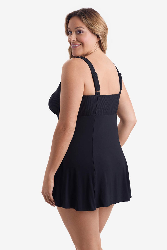 Woman turned left wearing a black swim dress 