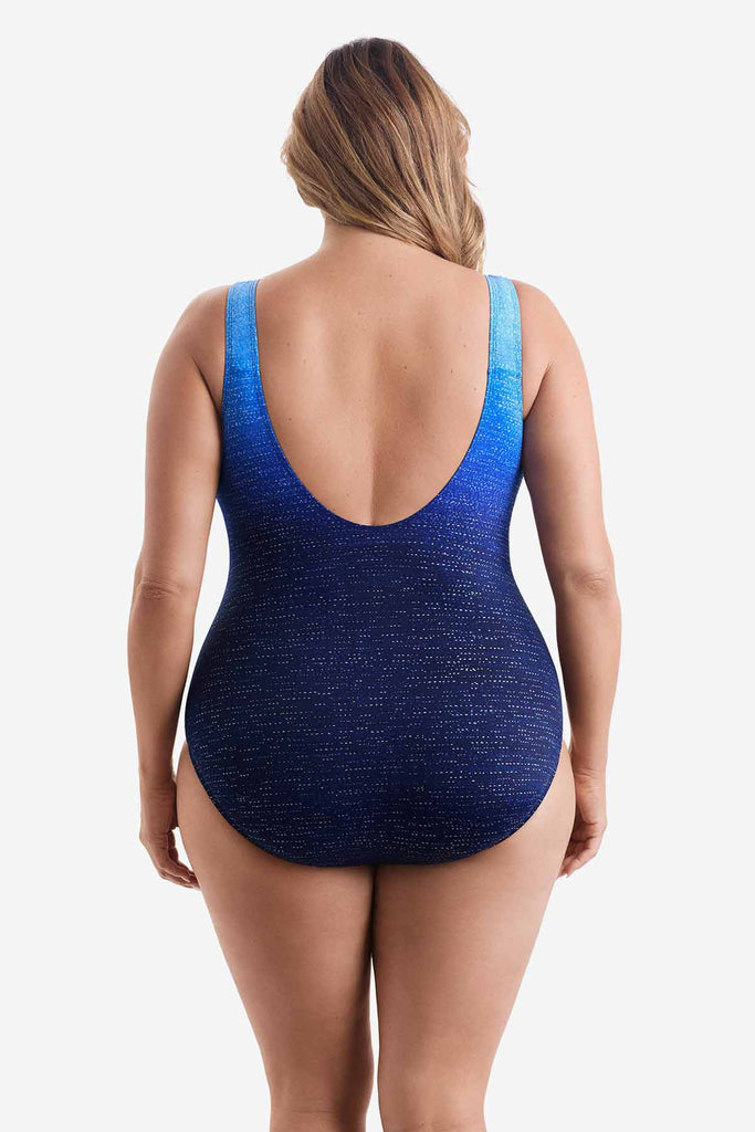 Woman faced away wearing a one-piece swimsuit with a blue ombre pattern