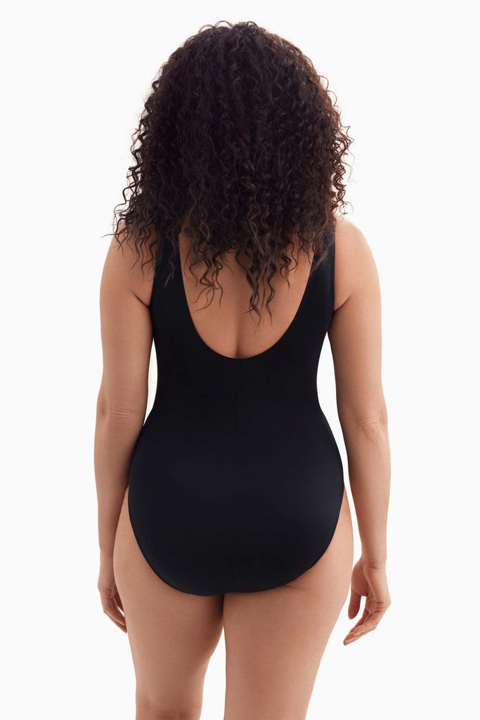 Woman faced away wearing a one-piece swimsuit