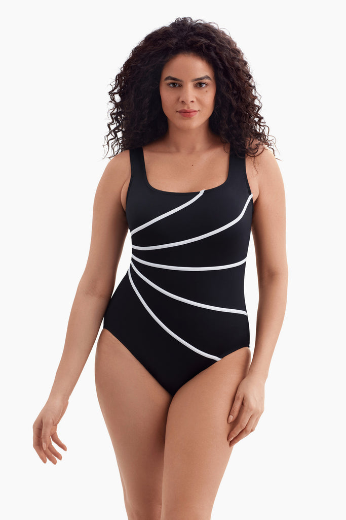 Woman wearing a one-piece swimsuit with four white streaks on the front