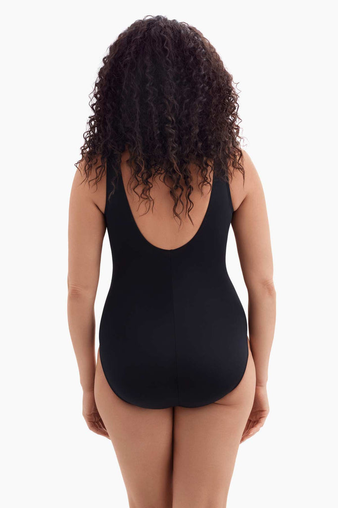 Woman faced away wearing a one-piece swimsuit