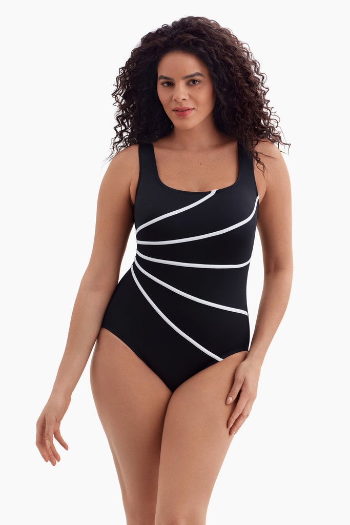 Woman wearing a one-piece swimsuit with five white streaks on the front