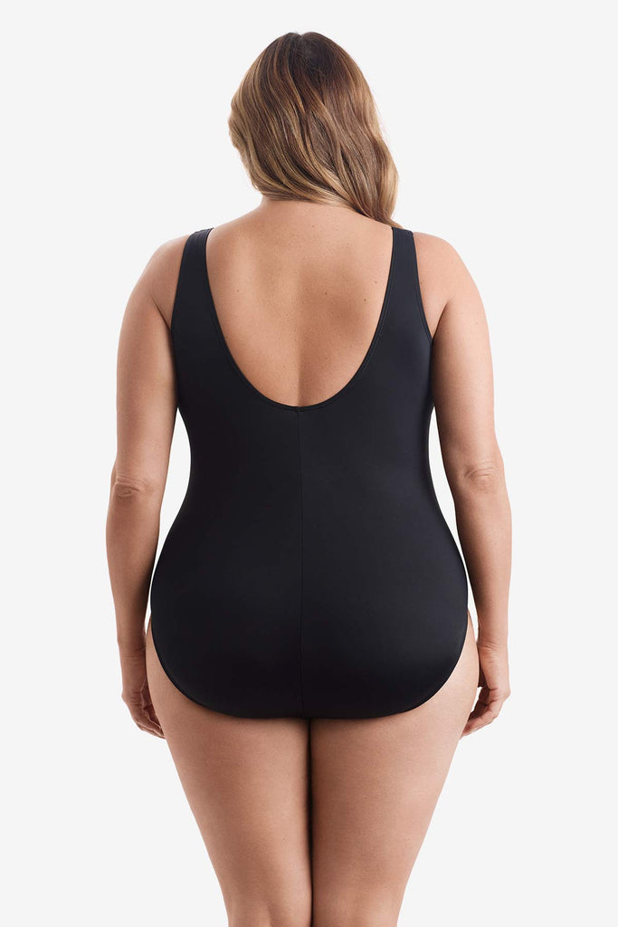 Woman faced away wearing a one-piece swimsuit 