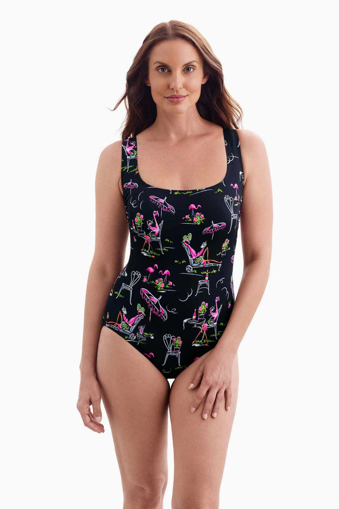 Woman wearing a black one-piece swimsuit with a flamingo print