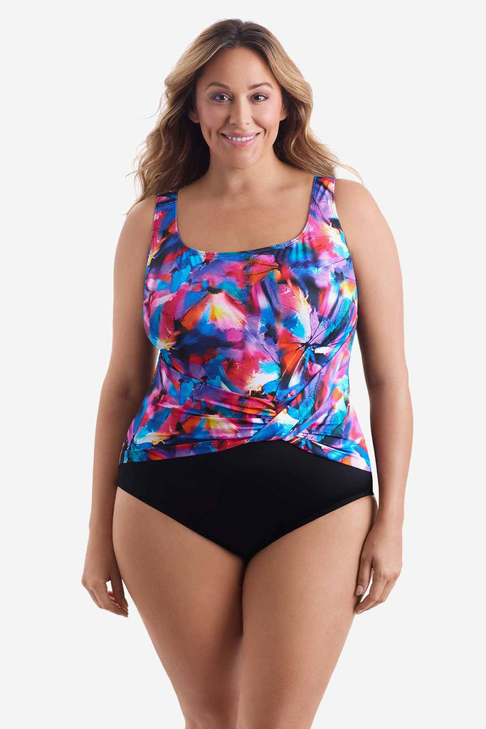 Woman wearing one-piece swimsuit with a multicolored watercolor print