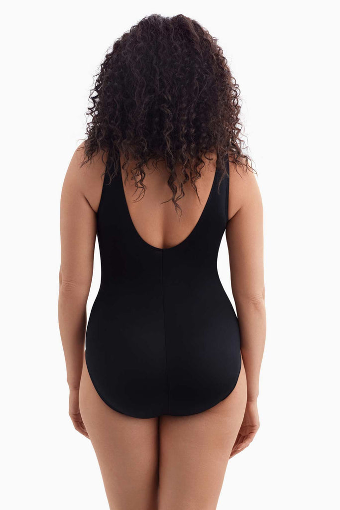 Woman faced away wearing a one-piece swimsuit