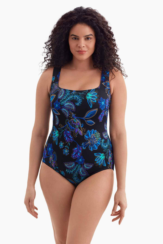 Woman wearing a one-piece swimsuit with a blue floral pattern