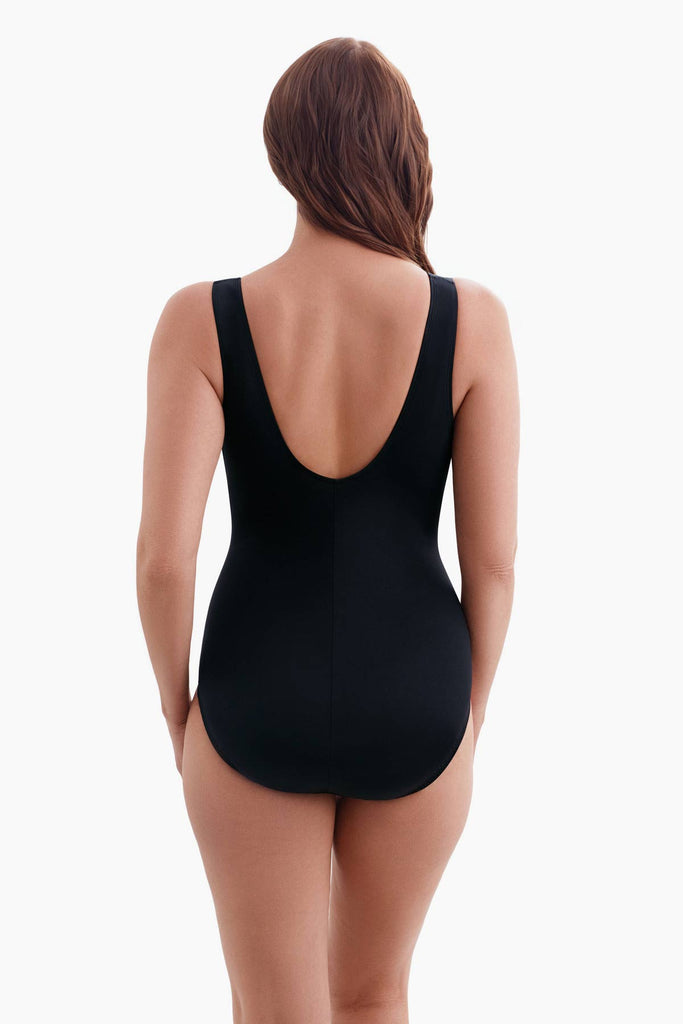 Woman faced away wearing a one-piece swimsuit