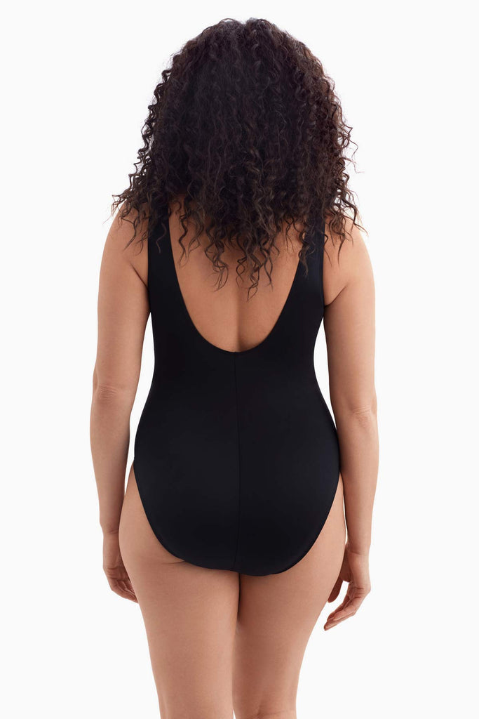 Woman faced away wearing a one-piece swimsuit 