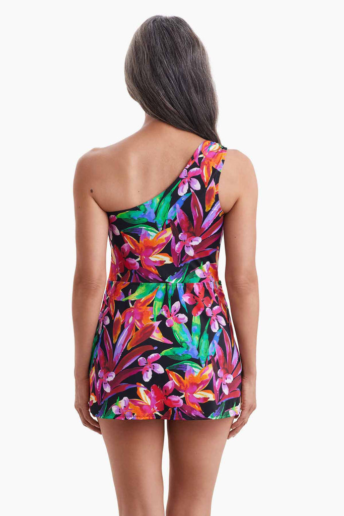 Woman faced away wearing a one shoulder swim dress with a multicolored floral print