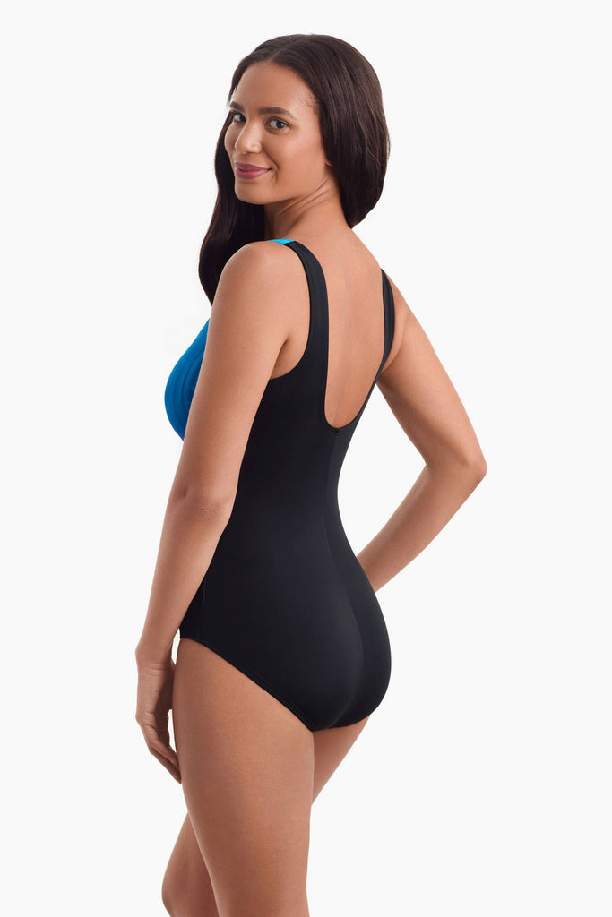 Woman facing left to show off the side detail of swimsuit