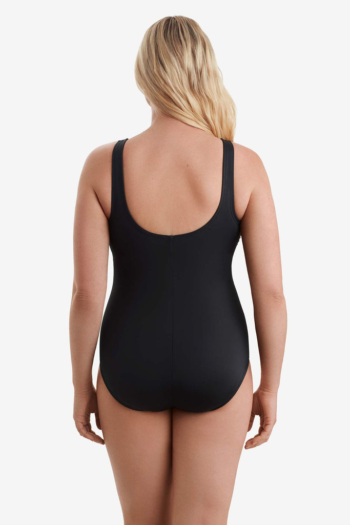 Woman facing away showing the back of the swimsuit