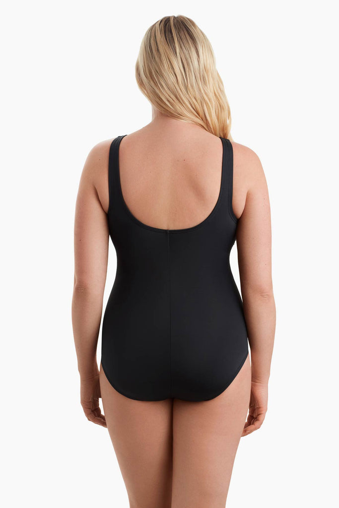 Woman facing away wearing a one-piece swimsuit