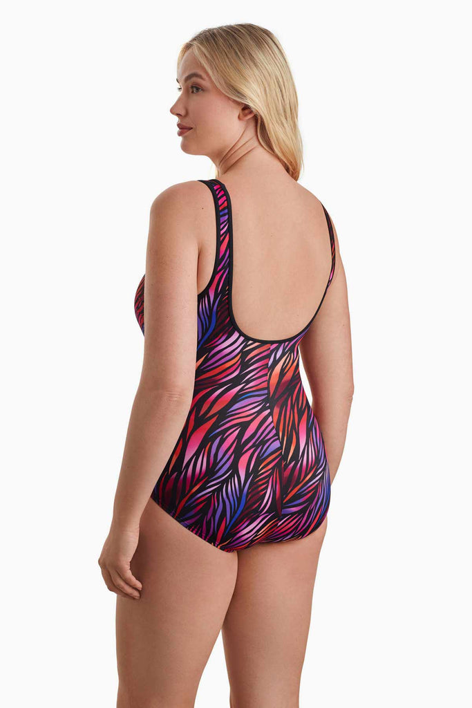 Woman facing left to show off detail of one piece swimsuit