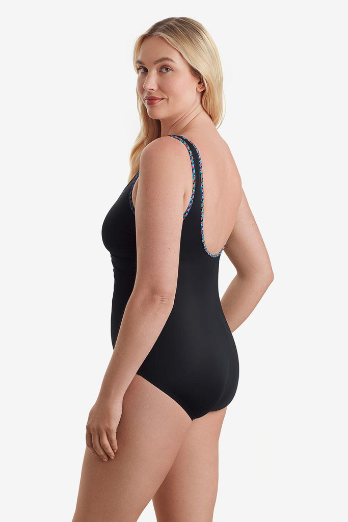 Woman turned to the left to show off trim detail of swimsuit