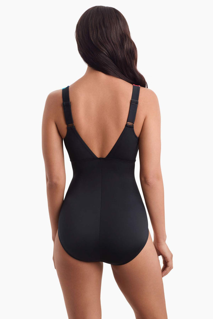 Woman facing away to show back detail of swimsuit