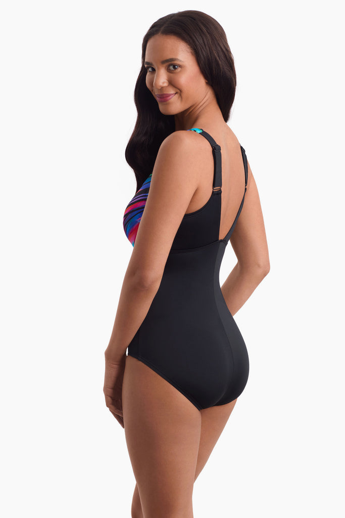 Woman facing left to show off detail of one piece swimsuit