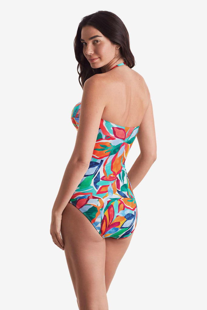 Woman turned left wearing a multicolored floral bandeau tankini top with matching swim bottoms