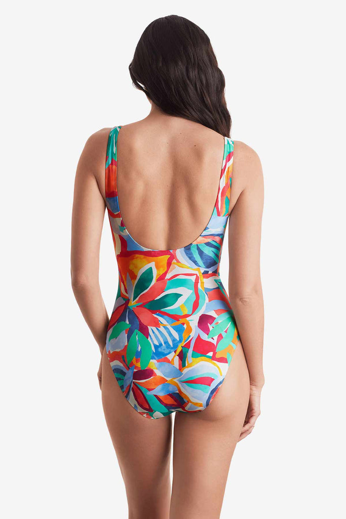 Woman turned away wearing a multicolor floral one-piece swimsuit