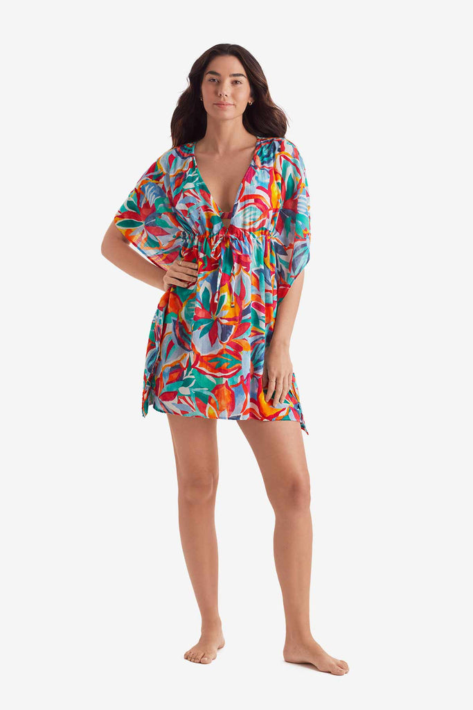 Woman wearing a multicolored floral caftan swim dress cover up