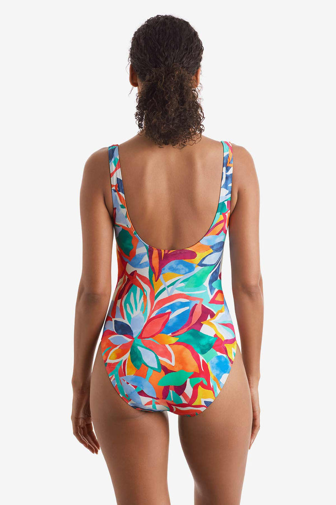 Woman turned away wearing a multicolored floral printed one-piece swimsuit