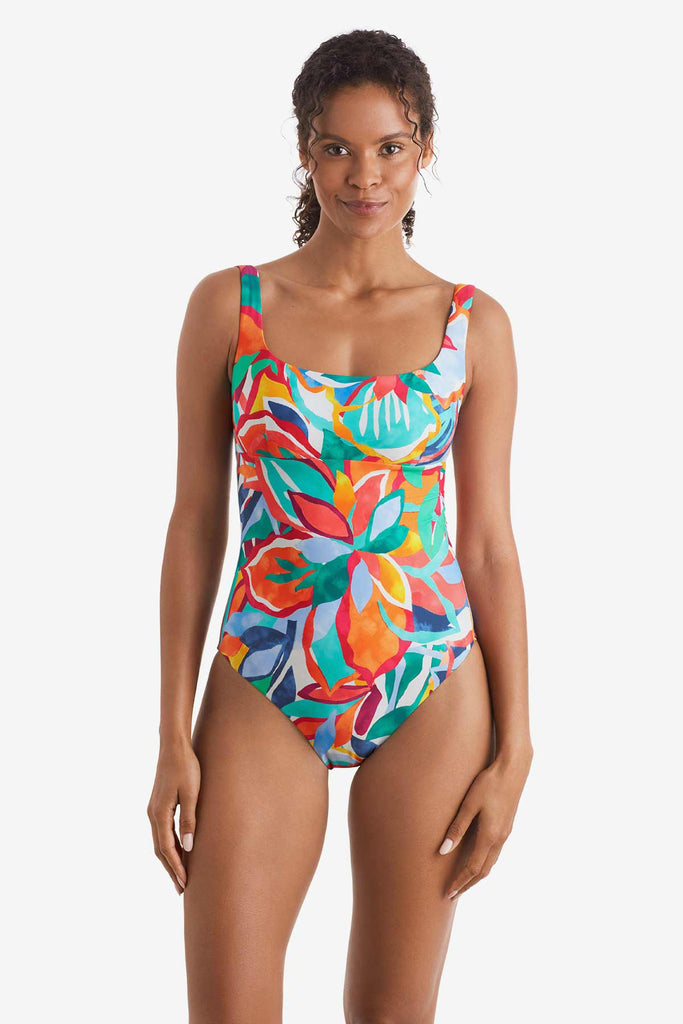 Woman wearing a multicolored floral printed one-piece swimsuit