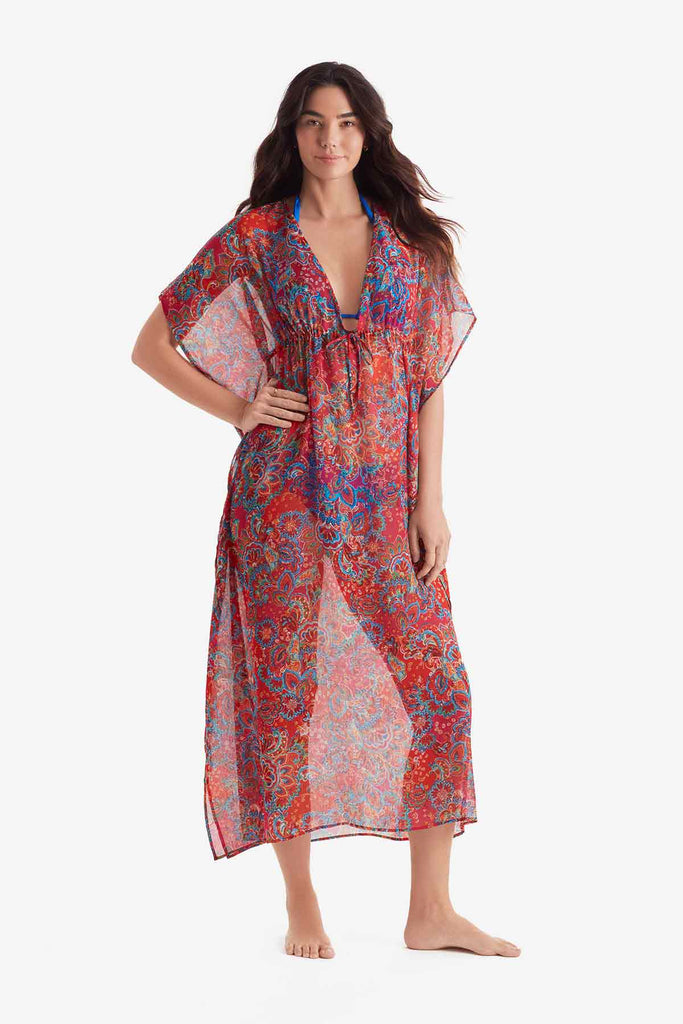 Woman wearing a sheer multicolor paisley print caftan swim cover up