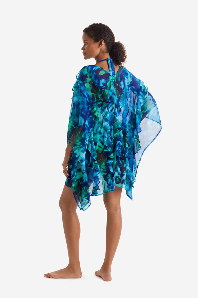 Woman faced left wearing a blue and green tie dye swim poncho cover up 