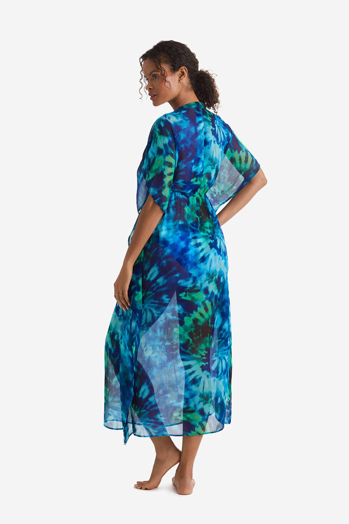 Woman turned left wearing a blue and green tie dye caftan swim dress cover up