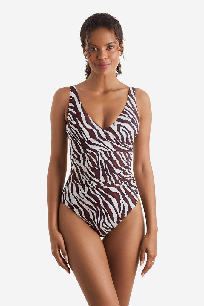 Woman wearing a one-piece zebra print swimsuit